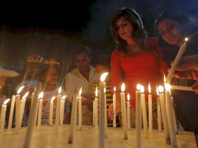 People light candles during a memorial service for the Indian soldiers killed in a militant attack at Pathankot air base, in Mumbai on Tuesday.