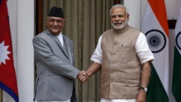 Nepal's Prime Minister Khadga Prasad Sharma Oli (L) shakes hands with his Indian counterpart Narendra Modi during a photo opportunity ahead of their meeting at Hyderabad House in New Delhi, India, February 20, 2016. REUTERS/Adnan Abidi