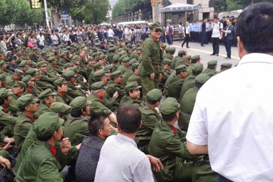 PLA veterans stage a sit-down protest outside government offices in Hubei province on May 4, 2015.